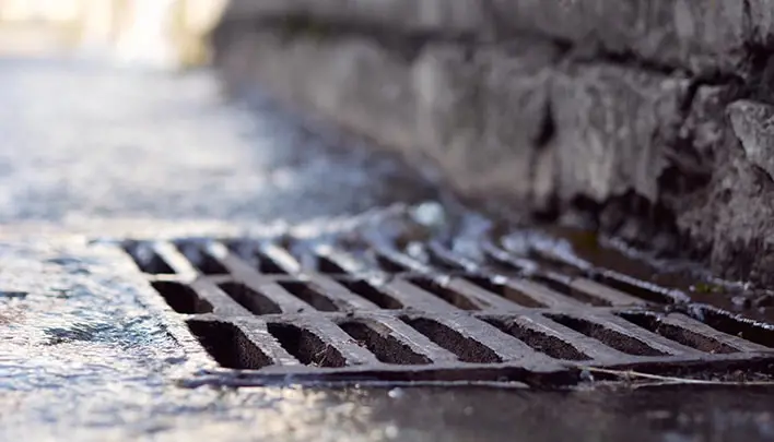 Rain water falling into sewerage drainage system
